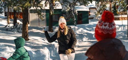 Family outside cabin in the snow in big bear